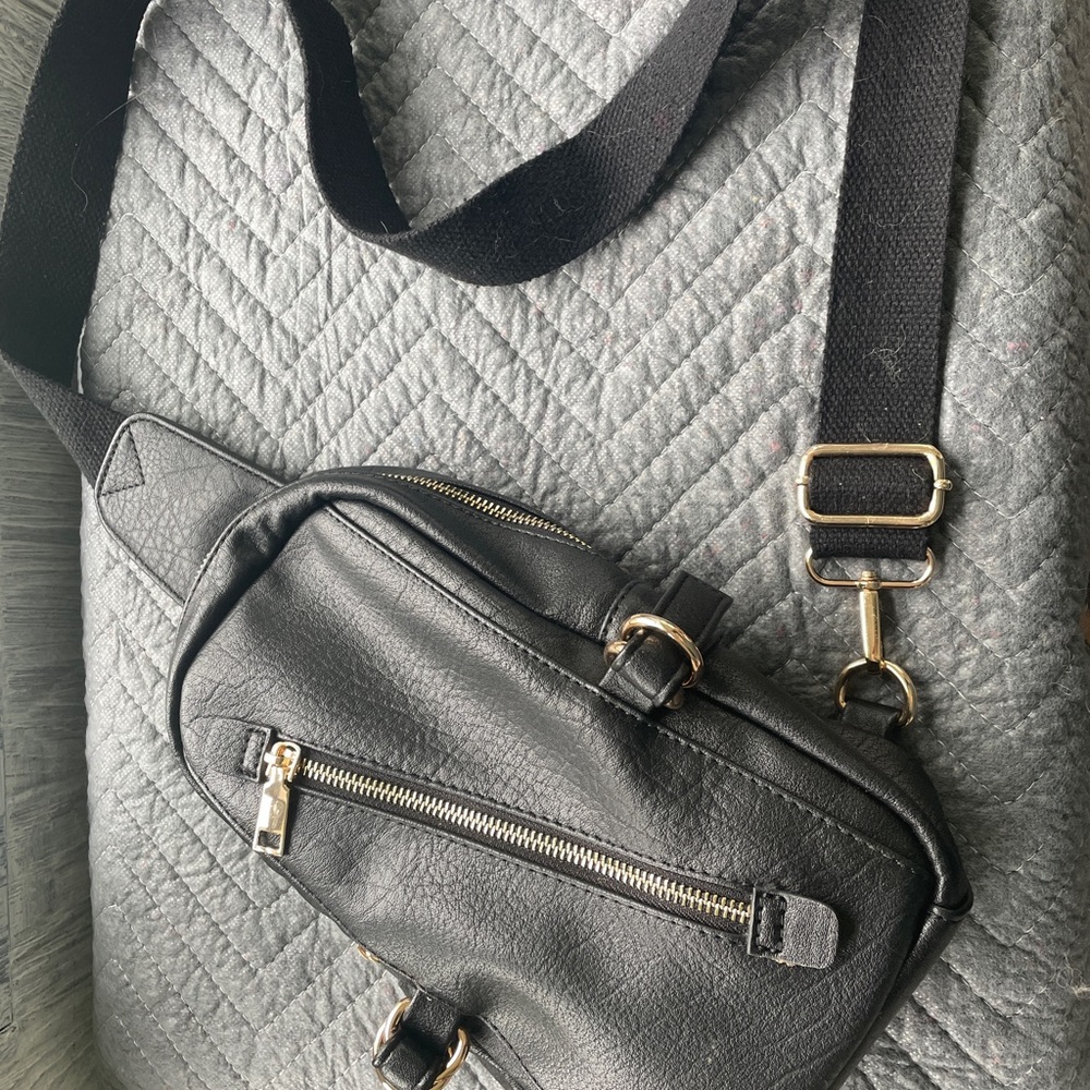 Black sling bag, gold accents in excellent condition